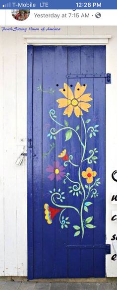 a blue door with flowers painted on it