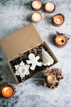 an open box with candles and some decorations