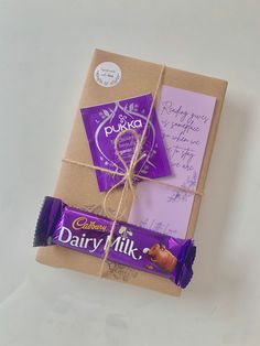 a box wrapped in brown paper and tied up with a purple candy bar wrapper