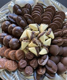 a platter filled with assorted chocolates on top of a metal plate,