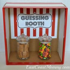 two glass jars filled with candy sitting in front of a sign that says, gusing booth