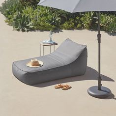 an inflatable lounge chair and umbrella on the ground next to a table with food