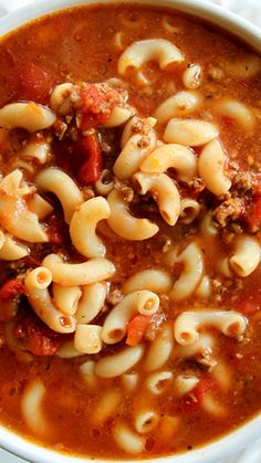 a white bowl filled with pasta and meat soup