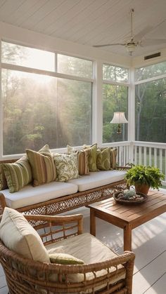 the sun shines through the windows onto a porch with wicker furniture and pillows