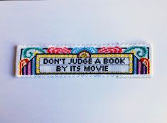 a bookmark with the words don't judge a book by its movie