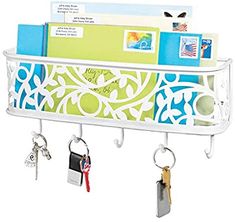 a white shelf with keys and key holders on it