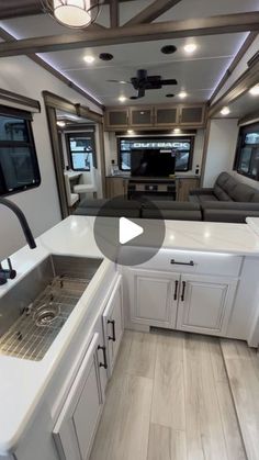 a kitchen with white cabinets and counter tops in a recreational vehicle that is equipped for travel