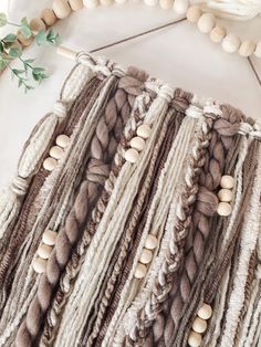 a close up of a piece of cloth with beads and wood beads on the end