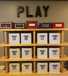 the shelves are filled with boxes and bins for storing items on them, along with a sign that says play