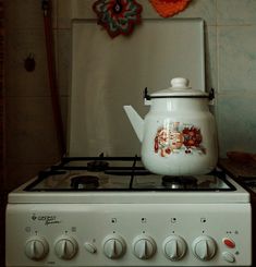 a tea pot sitting on top of a stove