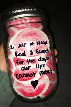 a person holding a jar with some writing on it