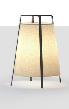 a lamp that is sitting on top of a white tablecloth with a black frame around it