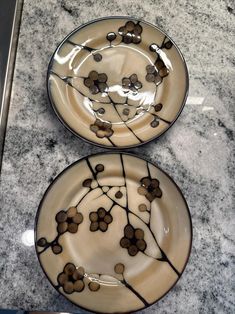 two plates sitting on top of a marble counter