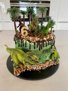 a dinosaur themed birthday cake on a table