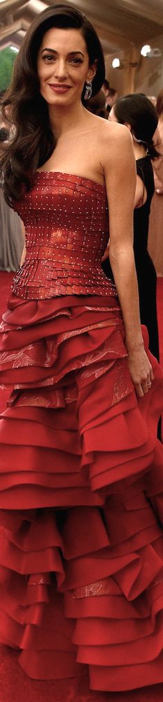 a woman in a red dress posing for the camera