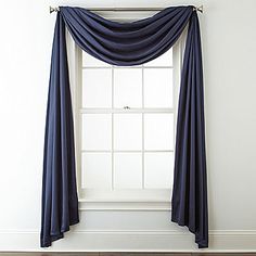 an open window with blue drapes on it