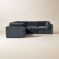 a large sectional couch sitting on top of a white floor