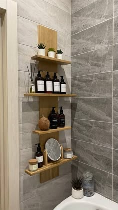 a bathroom with two shelves on the wall and a bathtub in the corner next to it