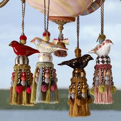 an ornate chandelier with birds and tassels hanging from it's sides