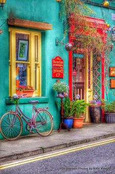 a bicycle is parked in front of a colorful building