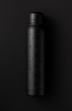 a black water bottle is shown against a dark background with tiny stars on the lid