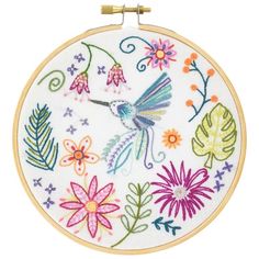 a colorful embroidered hummingbird and flowers on a white background