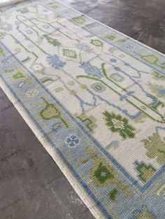 an area rug with blue and green designs on it