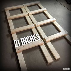 the number twenty inches is placed on top of some wood planks in order to make it look like they have been made out of plywood