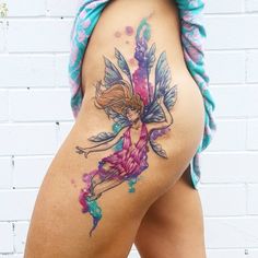 a woman's thigh with a tattoo on the side of her body and a fairy sitting on top of it