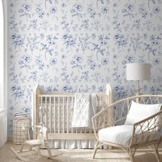 a baby's room with blue and white wallpaper