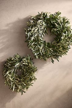 two olive wreaths sitting next to each other