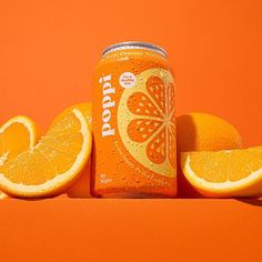 an orange soda can surrounded by sliced oranges