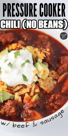 the pressure cooker chili no beans recipe in a white bowl with sour cream on top