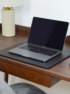 an open laptop computer sitting on top of a wooden desk next to a mouse and keyboard