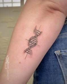 a tattoo on the arm of a woman with a double - stranded design in black ink