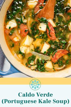 a large pot filled with soup and vegetables on top of a table next to a wooden spoon