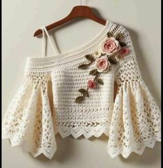 a crocheted top with flowers on it