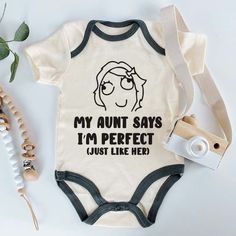 Celebrate the special bond between aunt and baby with this adorable 'My Aunt Says I'm Perfect' custom baby bodysuit! Perfect for nieces or nephews, this funny and cute outfit is ideal for pregnancy announcements, birth reveals, or baby showers. Made from soft, high-quality fabric, this unisex bodysuit is comfortable and stylish, featuring a playful saying that’s sure to bring a smile to Auntie's face. Whether it's a gift for a new baby or a fun way to announce 'coming soon,' this bodysuit is a must-have for every family. Available in multiple sizes and perfect for any occasion, it's a delightful way to celebrate the love and humor shared between an aunt and her little one! This baby bodysuit is machine washable, making it easy to care for. The romper is super soft and easy to wear and take Birthday Baby Announcement, Aunt Baby Clothes, Birth Reveal, Birth Plans, Auntie Baby, Funny Baby Shirts, Aunt Quotes, Cute Pregnancy Announcement, Pregnancy Announcements