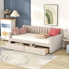 a living room scene with focus on the daybed and storage drawers under the bed