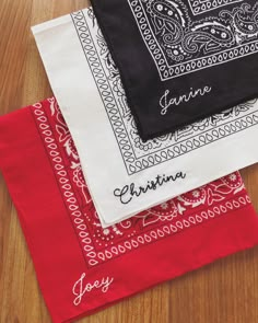 three different types of bandannas on a wooden table with the names of two people