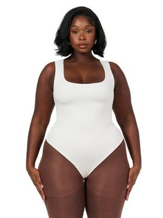 a woman in a white bodysuit