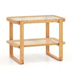 a wooden table with a glass top and two shelves on the bottom, against a white background