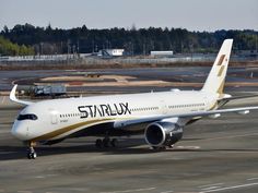 a large jetliner sitting on top of an airport tarmac