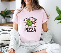 🍕 Slice Up Some Style with Our Olive Pizza T-shirt! 🍕 Celebrate your love for pizza and fun with our deliciously designed Olive Pizza T-shirt. Perfect for foodies and those who cherish whimsical designs, this graphic tee is a stylish and comfortable addition to your wardrobe. Featuring a playful olive and pizza slice design, this Olive Pizza shirt brings a taste of culinary joy to your everyday look. Designed for those who enjoy the delightful combination of olives on pizza and the simple plea Pizza T Shirt, Olive Pizza, Pizza Tee, Cute Pizza, Pizza Tshirt, Pizza Shirt, Pizza Slice, Everyday Look, Womens Clothing Tops