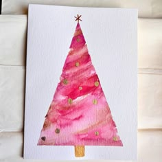 a pink christmas tree painted on white paper