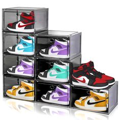 four clear boxes with different colored shoes in them on a white background, one is empty and the other has multiple pairs of sneakers