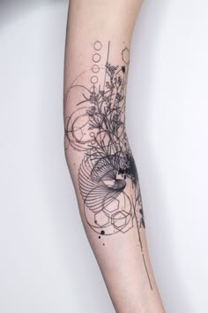 a woman's arm with an abstract tattoo design on the left side of her arm