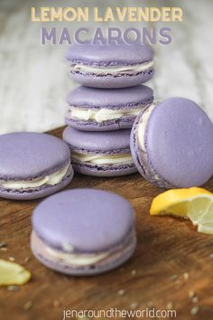 lemon lavender macarons are stacked on top of each other with lemon wedges