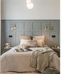 a large bed sitting in a bedroom next to two lamps