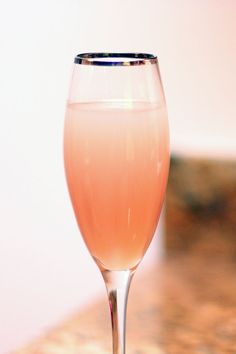 a glass filled with liquid sitting on top of a table